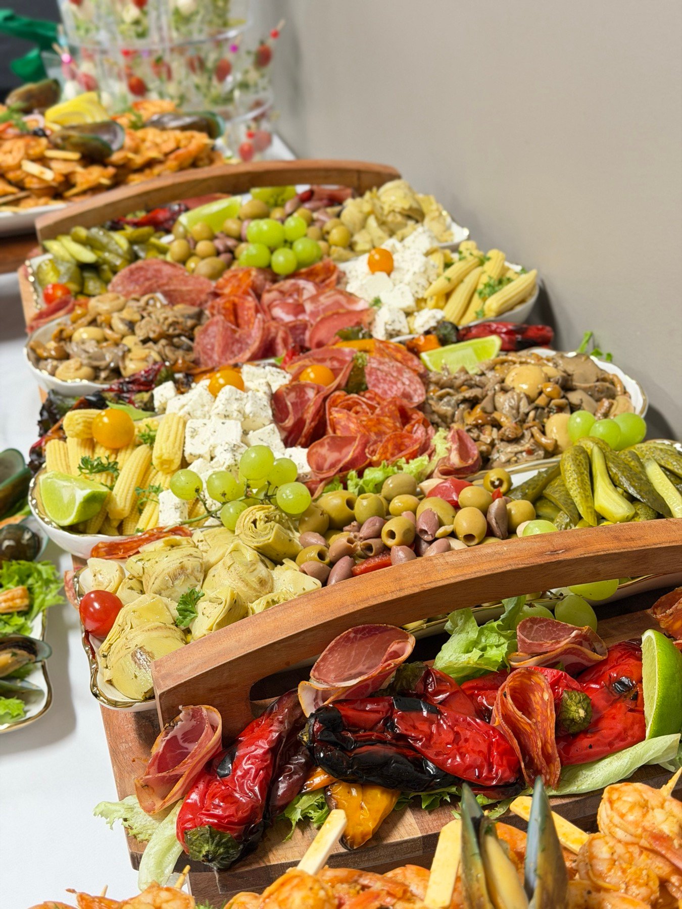 A generous antipasti display with cured meats, cheese and vegetables