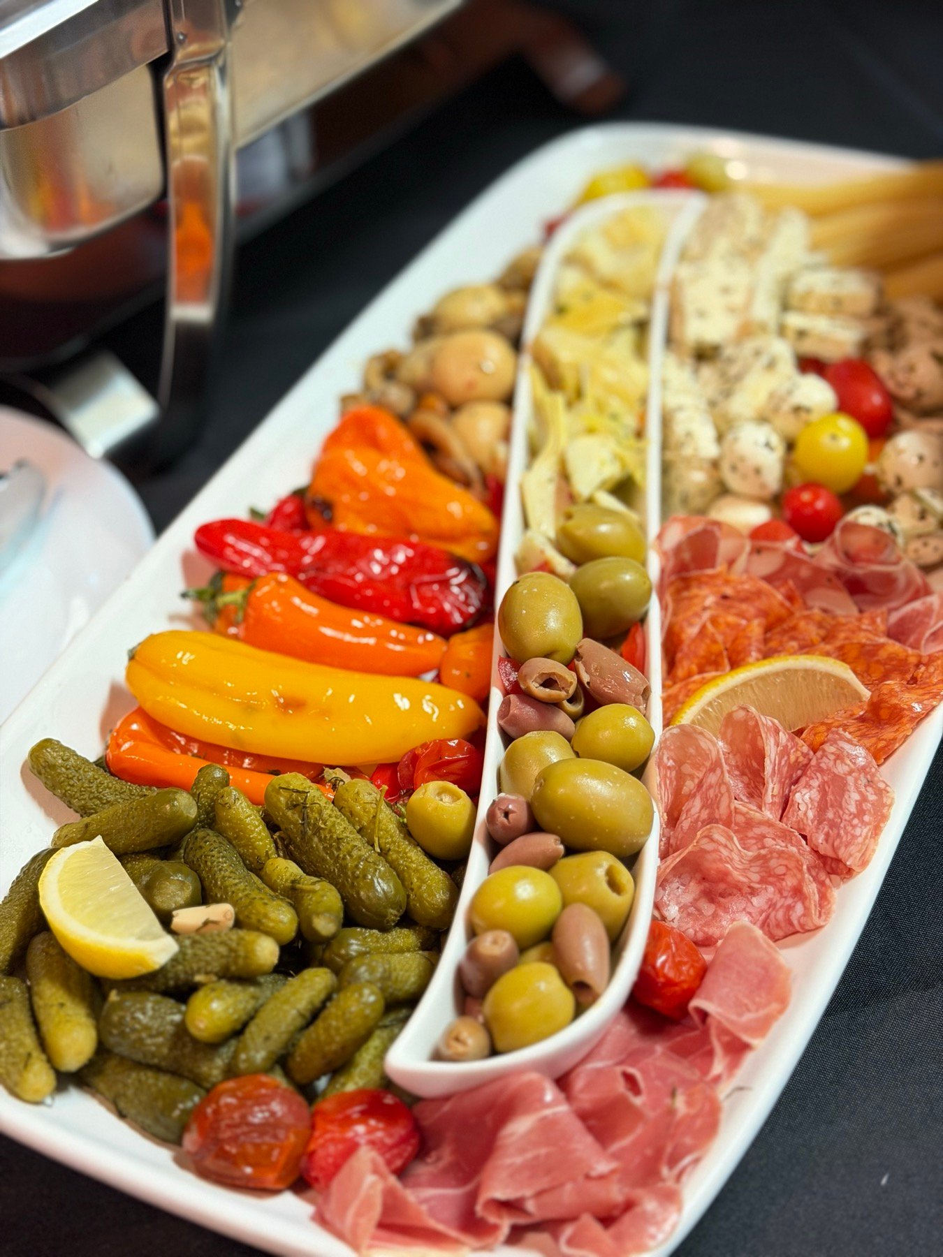 Antipasti platter with olives, peppers and cured meats