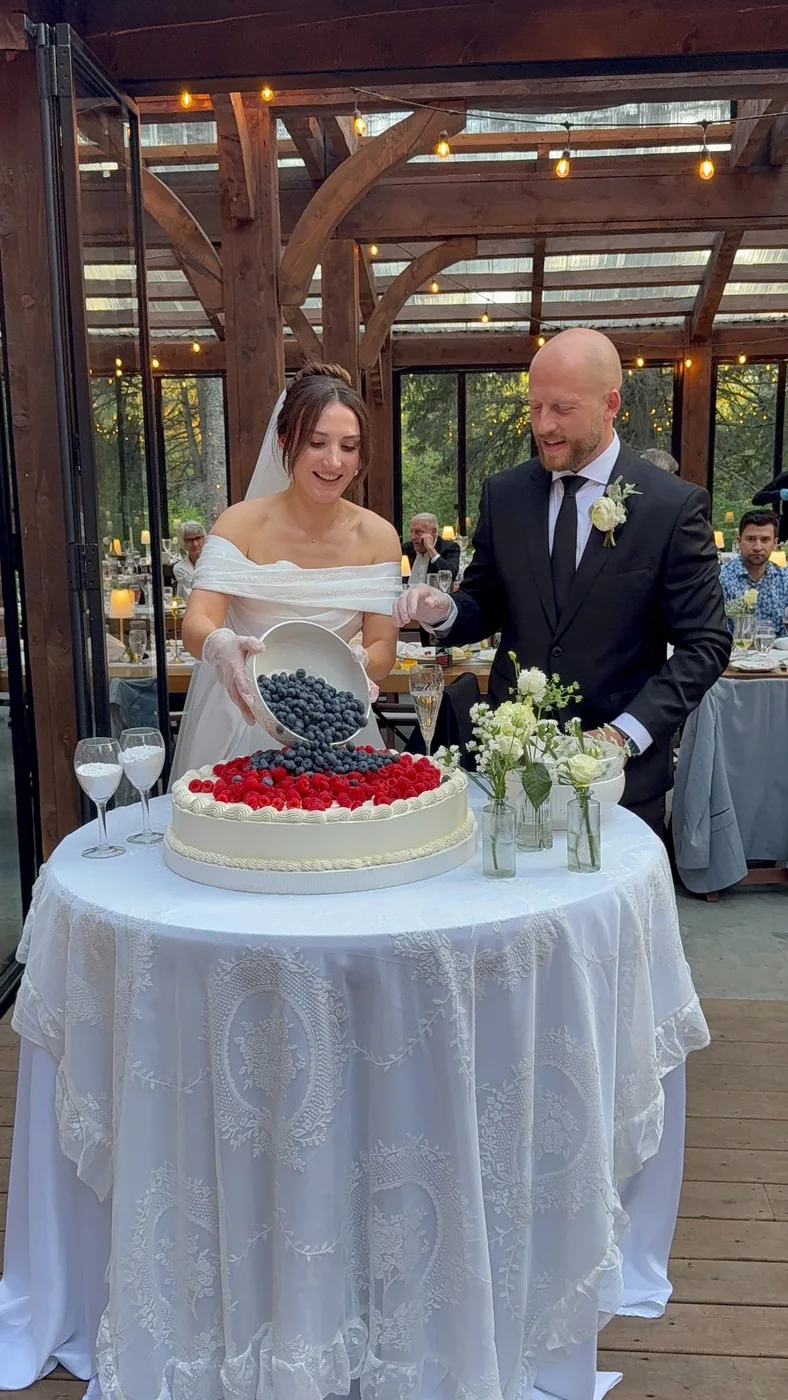 Newlyweds with an Italian-style wedding cake at The Valley Weddings