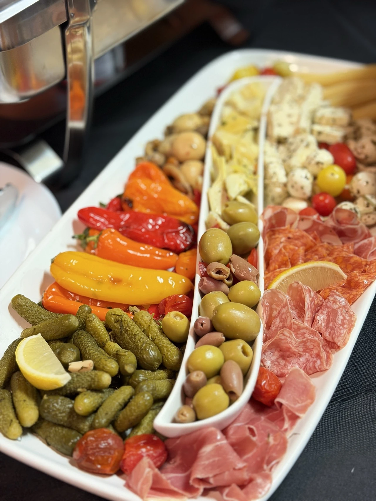 Antipasti platter with olives, peppers and cured meats