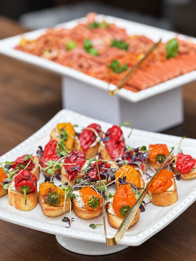 Colourful small canapes on white serving trays