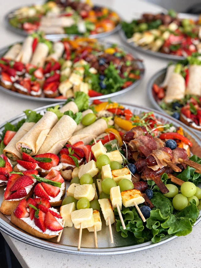 Platters of fruit, cheese, savoury bites and strawberry canapés