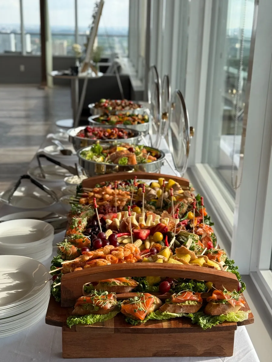 Catering in Sherwood Park – wedding and corporate buffet setup with appetizers, meats, and desserts on a wooden serving table
